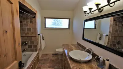 a bathroom with a sink and a mirror at Lakeside Oasis in Big Bear Lake