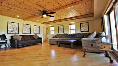 a living room with couches and a ceiling fan at Lakeside Oasis in Big Bear Lake