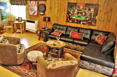 a living room with a black leather couch and chairs at Fire Pit & Steps to Village- Village Hideaway in Big Bear Lake