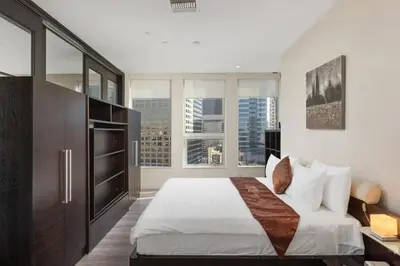 a bedroom with a large bed and large windows at 2 Bed 2 Bath Stylish Luxury Premium High-Rise Apartment in Los Angeles