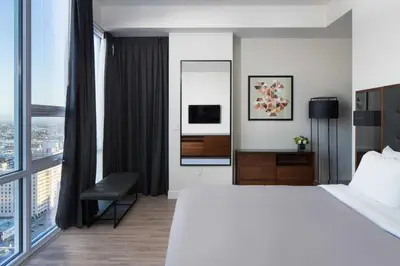 a hotel room with a bed and a large window at 2 Bed 2 Bath Stylish Luxury Premium High-Rise Apartment in Los Angeles