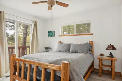 a bedroom with a bed and a ceiling fan at Sea to Ski Retreat in Big Bear Lake