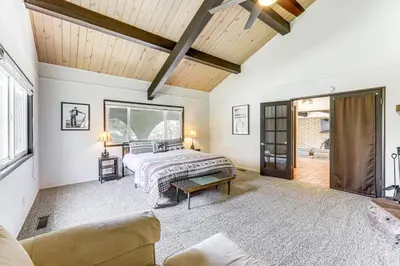 a bedroom with a bed and a living room at Private Hot Tub at Dog-Friendly Lake Arrowhead Gem in Lake Arrowhead