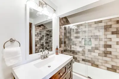 a white bathroom with a sink and a mirror at Private Hot Tub at Dog-Friendly Lake Arrowhead Gem in Lake Arrowhead