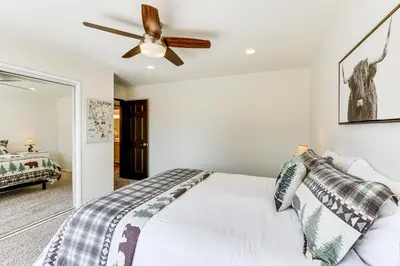a bedroom with a bed and a ceiling fan at Private Hot Tub at Dog-Friendly Lake Arrowhead Gem in Lake Arrowhead