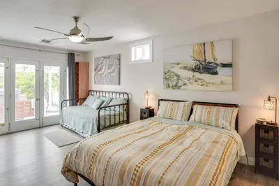 a bedroom with a bed and a dresser in it at 2 Mi to Cal State Long Beach Bungalow with Hot Tub! in Long Beach