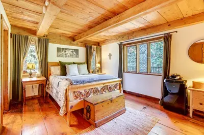 a bedroom with a bed and a wooden ceiling at Walk to Lake Gregory Family Retreat with Patio! in Crestline