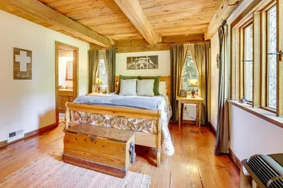 a bedroom with a bed and a wooden ceiling at Walk to Lake Gregory Family Retreat with Patio! in Crestline