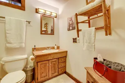 a bathroom with a toilet and a sink and a bunk bed at Walk to Lake Gregory Family Retreat with Patio! in Crestline