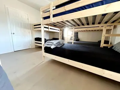 a bedroom with two bunk beds with black sheets at Hollywood Home in Los Angeles