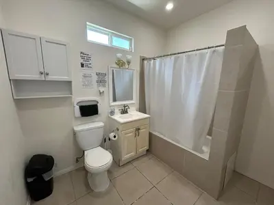 a bathroom with a toilet and a sink and a shower at Hollywood Home in Los Angeles