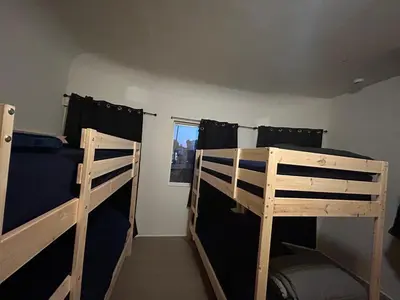 a bedroom with two bunk beds and a window at Hollywood Home in Los Angeles