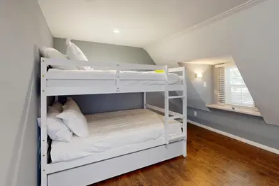 two bunk beds in a room with a window at Elevation Escape in Lake Arrowhead