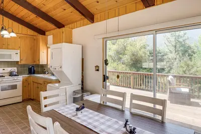 a kitchen with a table with two cats on it at Mountain-View Haven with Deck in Pine Mountain Club in Frazier Park