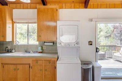 a kitchen with a refrigerator and a sink at Mountain-View Haven with Deck in Pine Mountain Club in Frazier Park