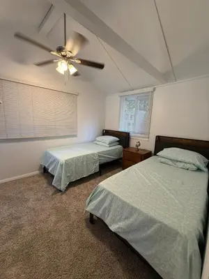 a bedroom with two beds and a ceiling fan at Serene Lakefront Escape in LA in Lake Hughes