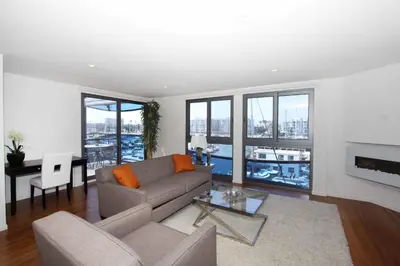 a living room with a couch and a table at Prime Stays - Suite Elegance by MDR Marina & Venice - Pool, Hot Tub, Gym in Los Angeles