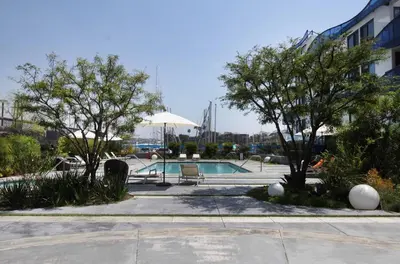 a swimming pool in a courtyard with trees and a building at Prime Stays - Suite Elegance by MDR Marina & Venice - Pool, Hot Tub, Gym in Los Angeles