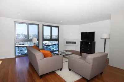 a living room with two chairs and a television at Prime Stays - Suite Elegance by MDR Marina & Venice - Pool, Hot Tub, Gym in Los Angeles