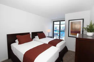 a bedroom with two beds and a desk and a window at Prime Stays - Suite Elegance by MDR Marina & Venice - Pool, Hot Tub, Gym in Los Angeles