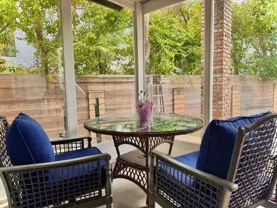 a porch with a glass table and two chairs at West LA - Family House & Private Yard - 10 mins from LAX & Beach in Los Angeles