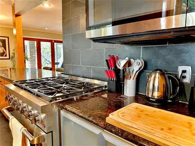 a kitchen with a stove and a counter top at West LA - Family House & Private Yard - 10 mins from LAX & Beach in Los Angeles