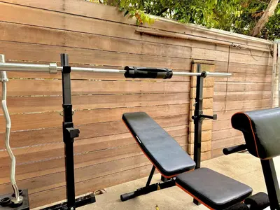 a home gym with two chairs next to a fence at West LA - Family House & Private Yard - 10 mins from LAX & Beach in Los Angeles