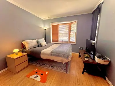 a bedroom with a large bed and a window at West LA - Family House & Private Yard - 10 mins from LAX & Beach in Los Angeles