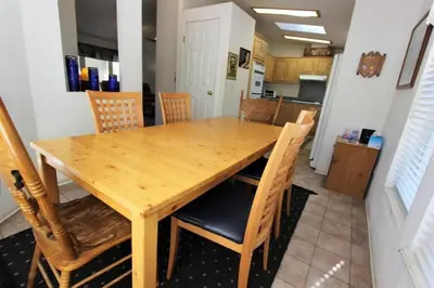 a wooden table and chairs in a kitchen at Bluebird Cottage in Big Bear Lake