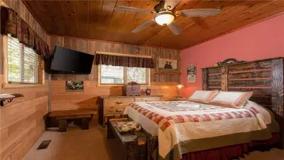 a bedroom with a bed and a flat screen tv at Hot Tub, Near Village/Lake - Kelly`s Kottage in Big Bear Lake