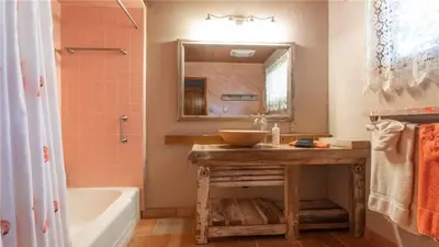 a bathroom with a sink and a mirror and a tub at Hot Tub, Near Village/Lake - Kelly`s Kottage in Big Bear Lake