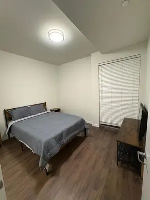 a bedroom with a bed and a television in it at Poolside Palace in Los Angeles