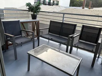 a group of chairs and a table on a balcony at Poolside Palace in Los Angeles