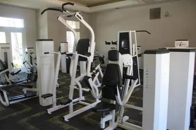 a gym with several tread machines in a room at Luxury 3 Bedroom Apartment in Santa Clarita