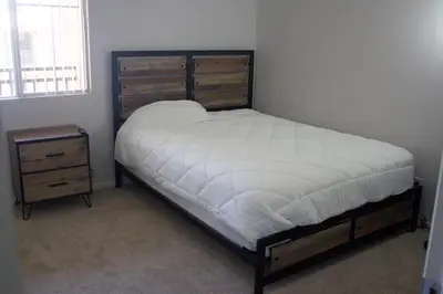 a bedroom with a bed and a dresser and a bed sidx sidx sidx sidx at Luxury 3 Bedroom Apartment in Santa Clarita
