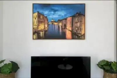 a painting of a canal on a wall at By The Coast Living in Santa Monica Pier Promenade in Los Angeles
