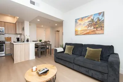 a living room with a couch and a table at By The Coast Living in Santa Monica Pier Promenade in Los Angeles
