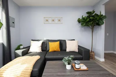 a black leather couch in a living room at 3bedroom 2bath Unit complementary parking onsite in Los Angeles