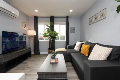 a living room with a couch and a tv at 3bedroom 2bath Unit complementary parking onsite in Los Angeles