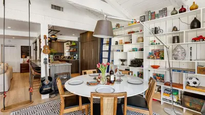 a dining room with a white table and chairs at Chic LA Hideaway w Soaking Tub Firepit Lounge Tranquil Backyard in Los Angeles