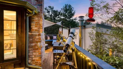 a telescope on the balcony of a house at Chic LA Hideaway w Soaking Tub Firepit Lounge Tranquil Backyard in Los Angeles