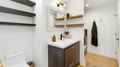 a bathroom with a sink and a mirror at Chic LA Hideaway w Soaking Tub Firepit Lounge Tranquil Backyard in Los Angeles