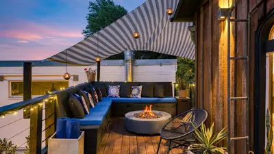 a patio with a couch and a fire pit at Chic LA Hideaway w Soaking Tub Firepit Lounge Tranquil Backyard in Los Angeles