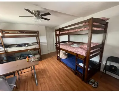 a room with two bunk beds and a table at Females room bunk beds in Los Angeles