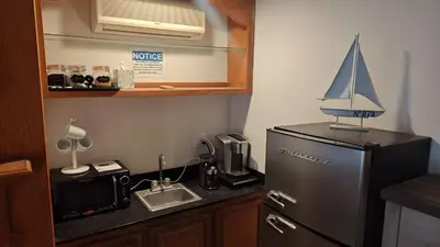 a small kitchen with a sink and a refrigerator at Golden House in Santa Clarita