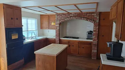 a kitchen with a brick arch in the middle of it at Golden House in Santa Clarita