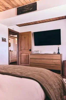a bedroom with a bed and a flat screen tv at Malibu ranch retreat in Malibu