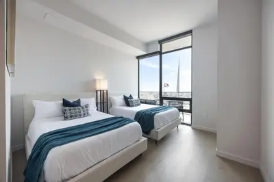 a bedroom with two beds and a large window at Seven Mile Penthouse Dream Hollywood View Pool in Los Angeles