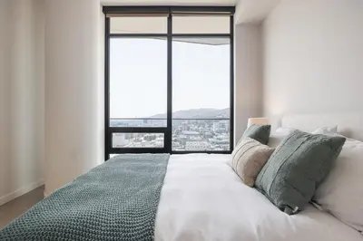 a bedroom with a white bed with a large window at Seven Mile Penthouse Dream Hollywood View Pool in Los Angeles