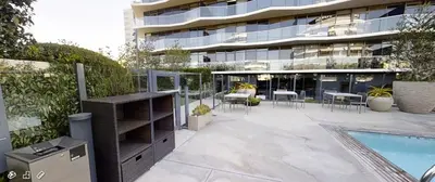 a patio with a swimming pool and a building at Seven Mile Penthouse Dream Hollywood View Pool in Los Angeles